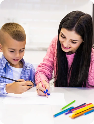 Adult and a child draw together at a table