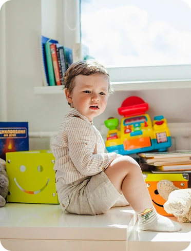 Young child looking at toys.